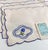 Charming vintage linen cocktail napkins with delicate blue floral embroidery and scalloped edges, crafted in Portugal and...