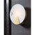 Houston sconce showcases a round piece of natural alabaster secured by natural brass-finished metal framing. Light shines...
