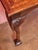 The solid oak console table is hand-carved in the English Chippendale style with a top decorated with parquetry. The legs...