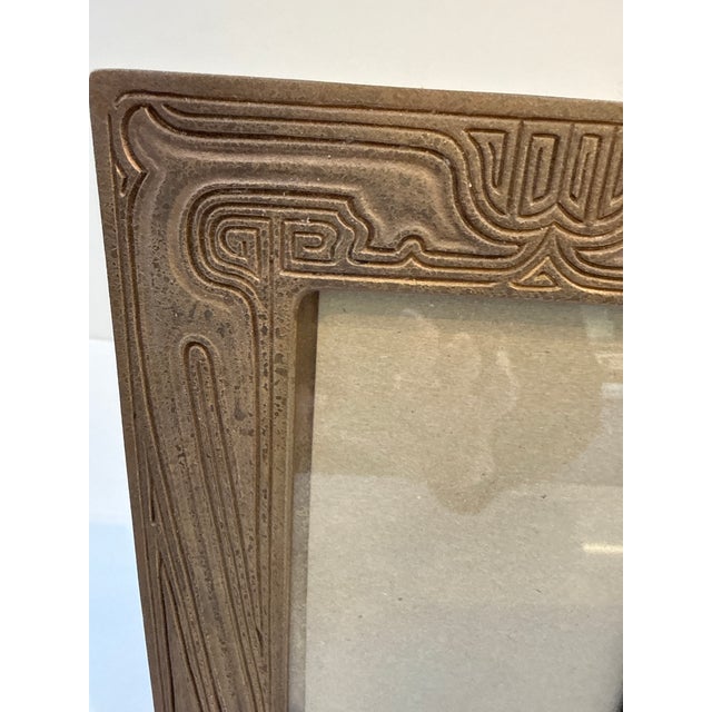 A Tiffany Studio New York bronze picture frame from the “Chinese” desk set pattern The intricately carved gilt bronze...