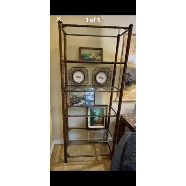 A striking vintage faux bamboo étagère featuring an elegant antiqued bronze finish and five tempered glass display...