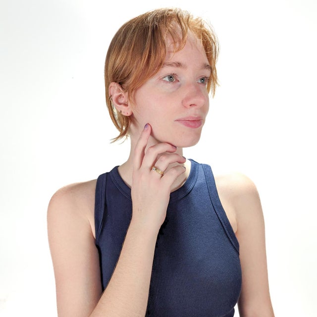 A fine studio Modernist engagement ring. In 14k yellow gold setting. Prong set with a round brilliant cut white diamond....