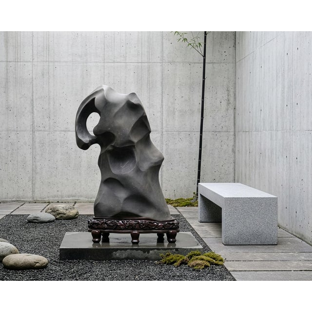 An immense and rare large-scale Chinese scholar's limestone Lingbi rock or water stone presented on an intricately carved...