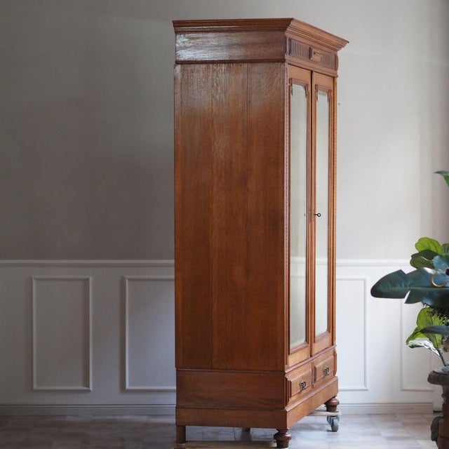 A two-door oak wardrobe from the Gründerzeit period, dating from around 1890–1900 and reflecting the stylistic conventions...