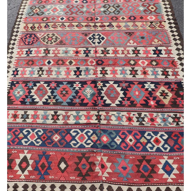 Measures: 4'9 x 6'9 Persian Kilim Rug with Bold Tribal Geometric Patterns in Vivid Colors 4'9 x 6'9. Keivan Woven Arts/...