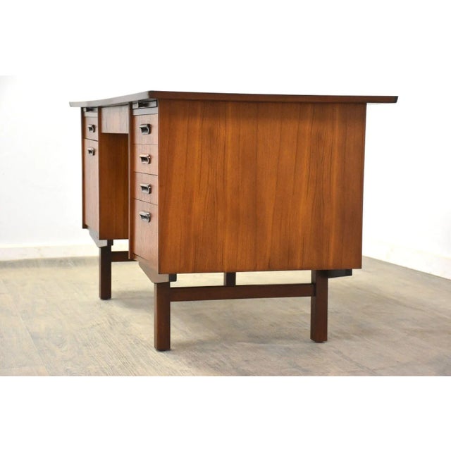 A mid century modern teak double bank desk with a finished back and a drawer for hanging files. Made in Denmark....
