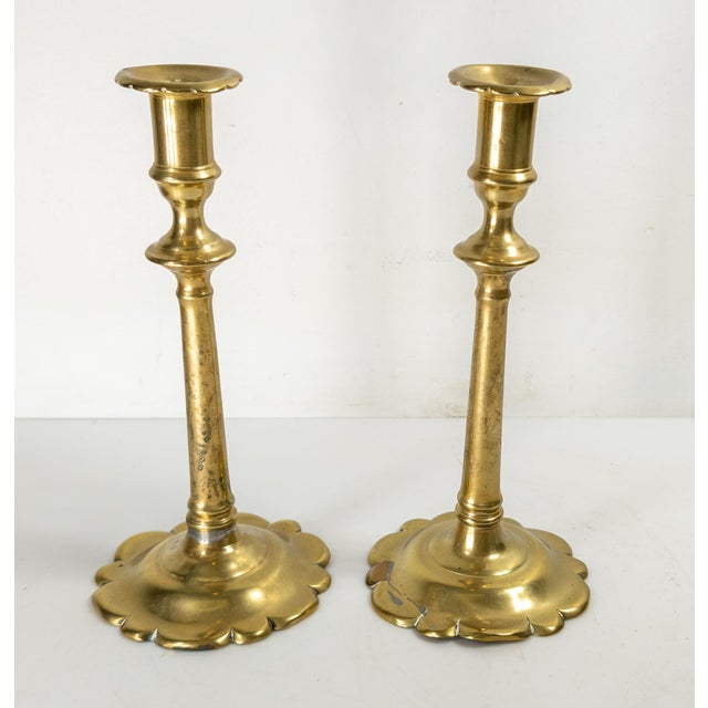 We are selling this nice pair of English Queen Anne brass candlesticks. These circa 1750 candlesticks have lobed petal...