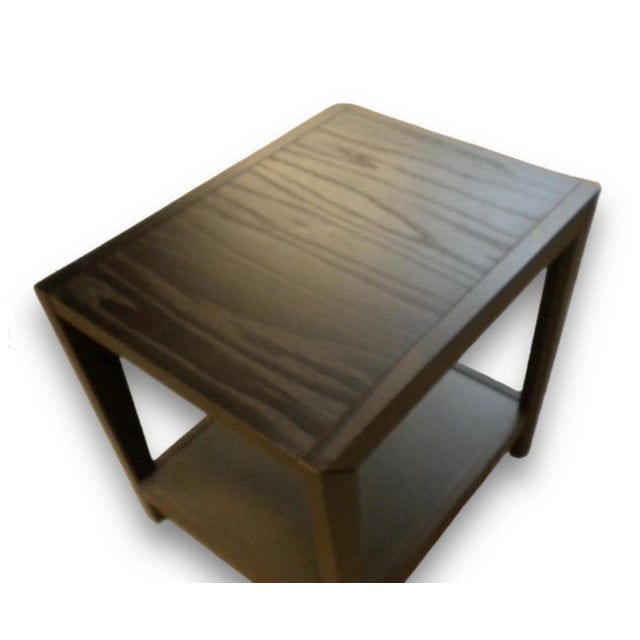 These particular tables exhibit a contemporary design with a dark wood finish and a slatted top, a style that has been...