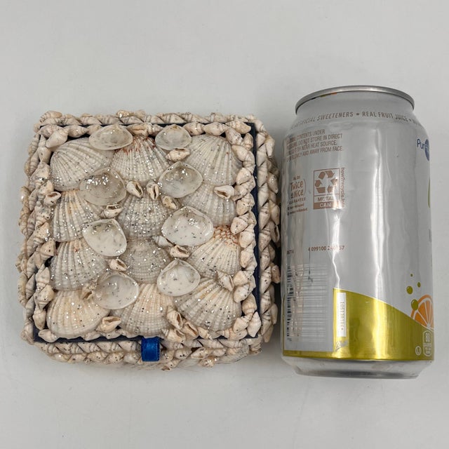 Vintage coastal sailors Valentine seashell encrusted trinket box. White, cream and gray seashells cover the box and lid...