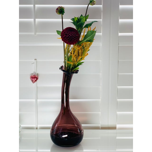 A dramatic vintage art glass vase, handblown in the 1960s, in a deep amethyst hue that shades to near-black at the base....