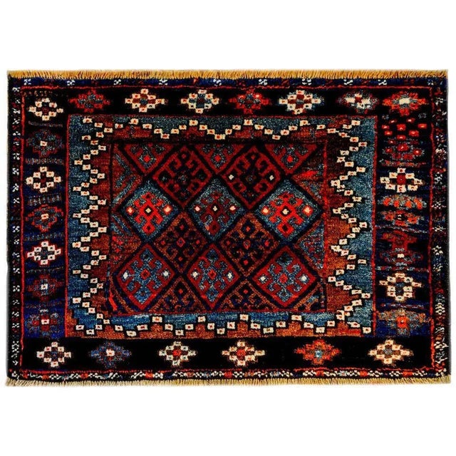 An early 20th century Persian Kurdish rug with a wonderful pattern containing multiple diamonds with geometric forms woven...