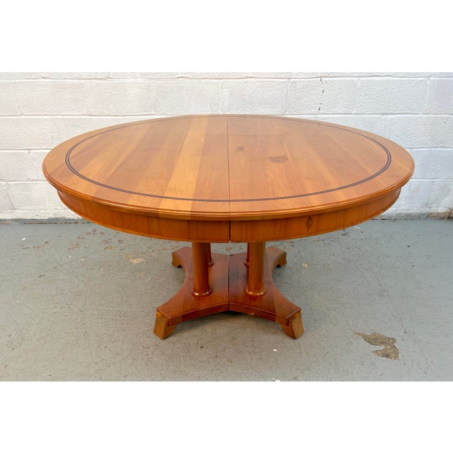 Elegant Stickley expanding dining table crafted in beautiful cherry, featuring a graceful oval top, rich warm finish, and...