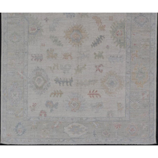 Textile Large Oushak Rug With Floral Motifs & Muted Colorful Tones on Neutral Background For Sale - Image 7 of 12