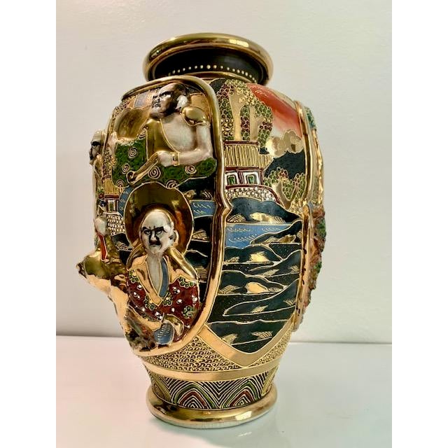 This is a stunning Japanese Satsuma Vase depicting the Immortals of Japan, with raised figures in gold and hand painted...