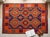 A handwoven Maimana kilim from northern Afghanistan on a deep indigo ground, worked with brilliant orange, crimson,...