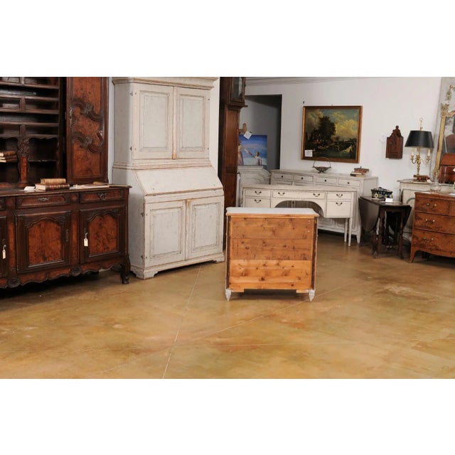 A Swedish Gustavian style gray painted chest from circa 1890 with three drawers, reeded accentuation and tapered feet....