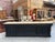 This vintage fir wood display case has been fully restored. It features a black-patinated frame and a large, unfinished...