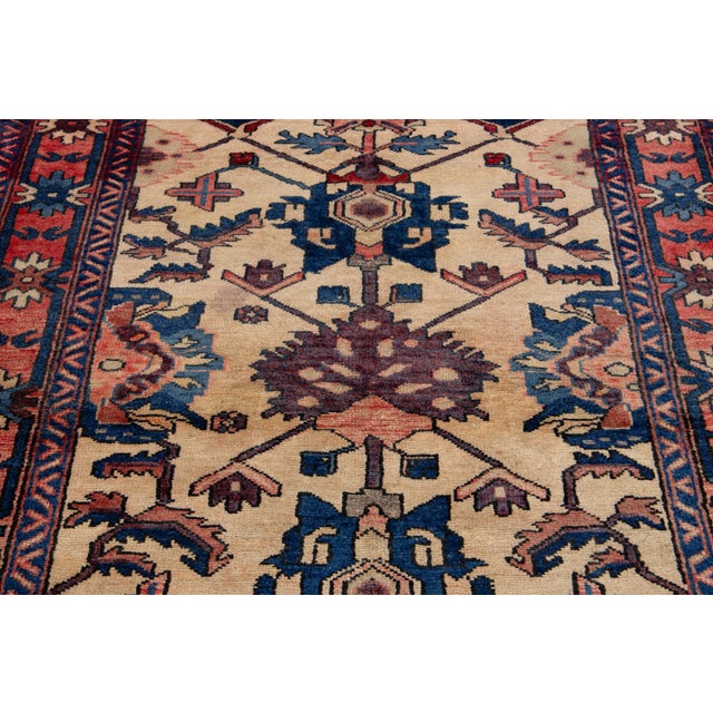 Vintage Persian Bakhtiari hand-knotted wool rug with multicolor allover design in a beige field. This rug measures 4'3'' x...
