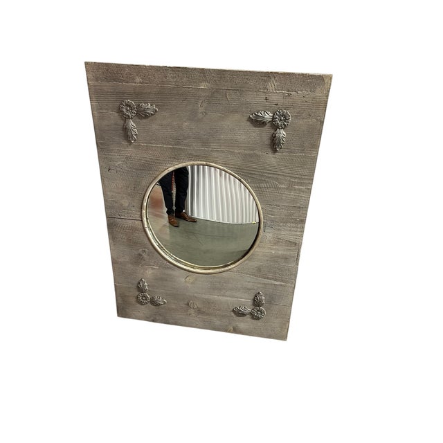 This rustic, contemporary wall mirror blends reclaimed wood styling with classical decorative accents The frame is square...