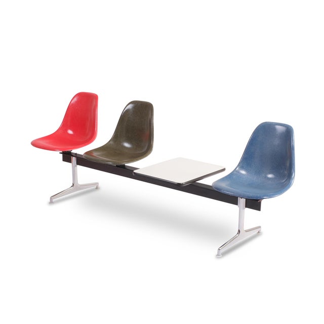 Eames Tandem Seating Group Design by Charles and Ray Eames Three fiberglass shell seats and a side table, crossbar with...