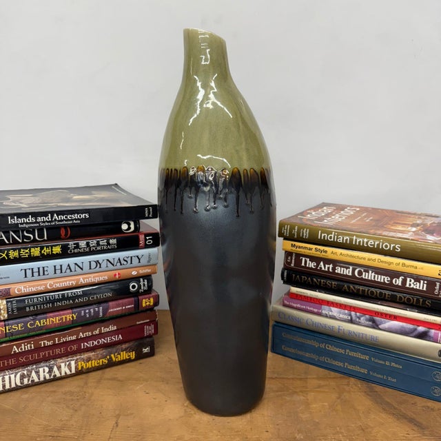 "About This Piece About This Piece Make a bold design statement with this tall ceramic vase, where organic tones and...