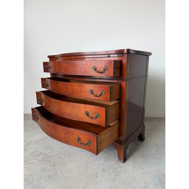 Elegant vintage mahogany chest inspired by classic Georgian design, featuring a graceful serpentine front, four spacious...