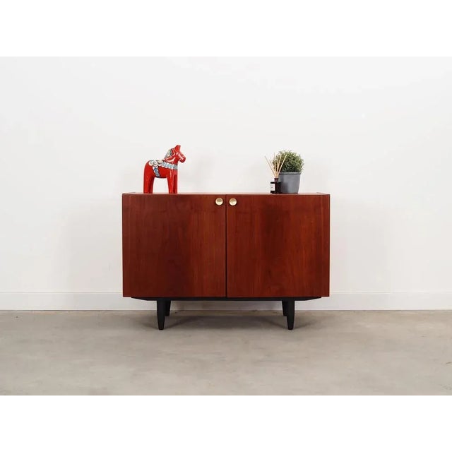 The cabinet was made in the 1970s, Danish production. The structure is covered with teak veneer. The legs are made of...