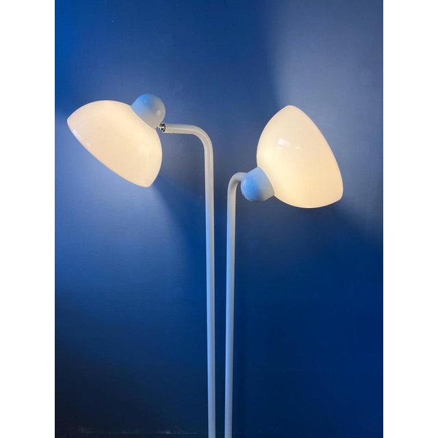 Uniquely shaped white vintage space age floor lamp with two acrylic glass shades. The acrylic glass shades produce a warm...