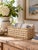 A vintage rectangular woven storage basket with an open lattice weave and natural ivory finish. Crafted from flexible...