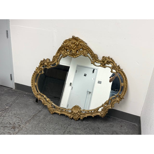 Design Plus Gallery presents a Rococo Style Wall Mirror from Marlock. The ornate frame surrounds shaped mirror glass with...