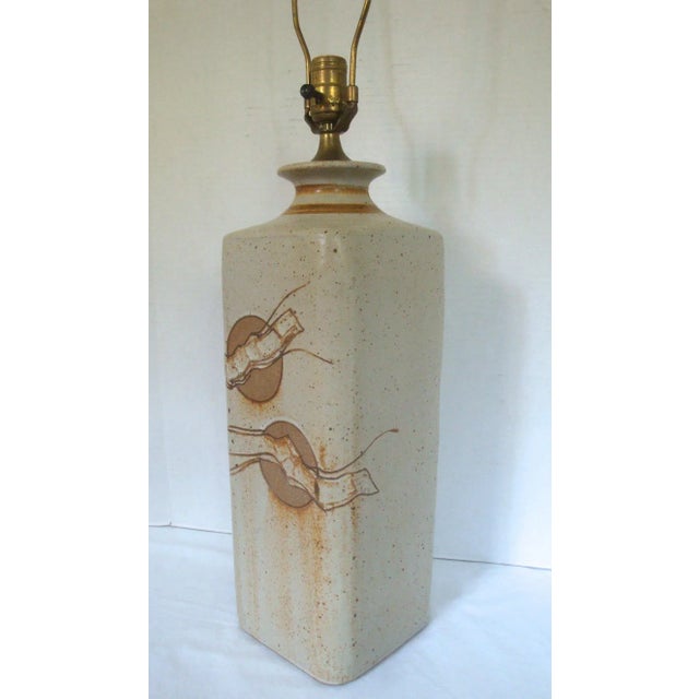 Striking one of a kind studio art pottery lamp in a tall rectangular form with incised circles and layered abstract ribbon...