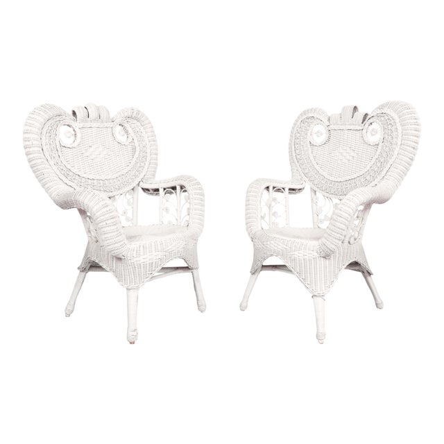 A pair of Heywood Wakefield wicker woven rattan armchairs circa 1920. Sculptural backs of woven wicker are pierced with...