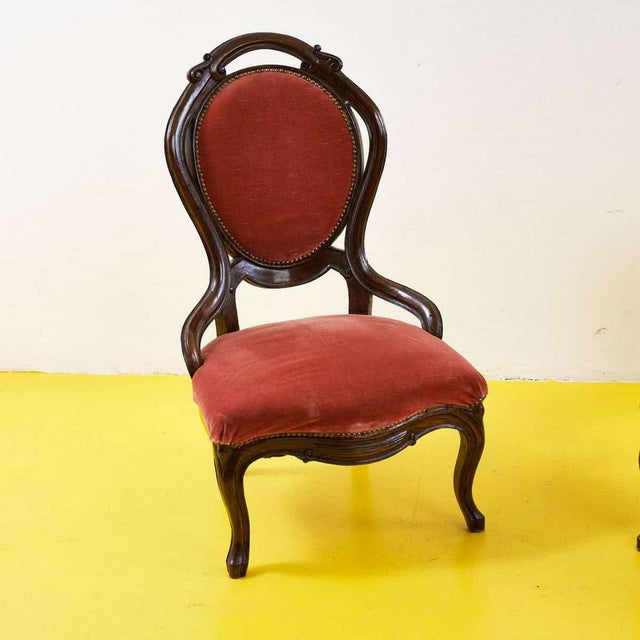 Discover the timeless appeal of these solid wood armchairs, finished with red velvet upholstery. Each chair features...
