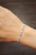 This elegant tennis bracelet embodies modern sophistication. Featuring a harmonious blend of natural round-cut blue...