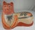 Large Tonala pottery cat in recumbent post, circa 1960s. Well modeled and painted with a pleasing countenance. Very good...