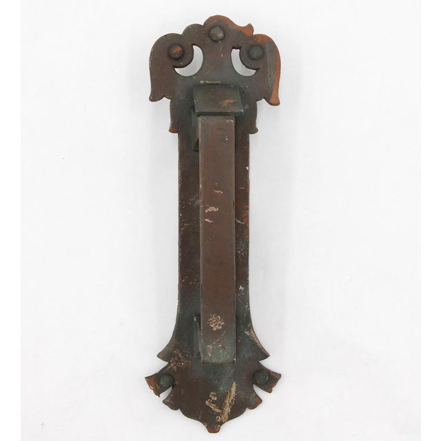 Arts & Crafts style door pull handle made of cast bronze with a cylinder lock cover. It features a rectangular handle with...