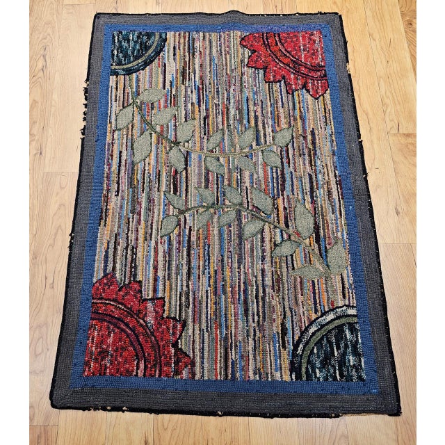 This distinctive Vintage American hand-hooked rug, crafted in the early 1900s in the New England region, is a beautiful...
