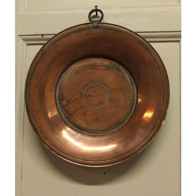Heavy antique hand made copper plates. These are very heavy quality copper, they have thick bases and one has a hanging...