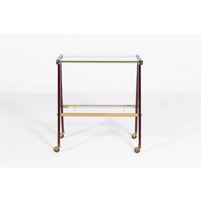 Beautiful Italian craftsmanship serving trolley/side table on wheels from 1960’s. Executed in wooden frame with 2 glass...
