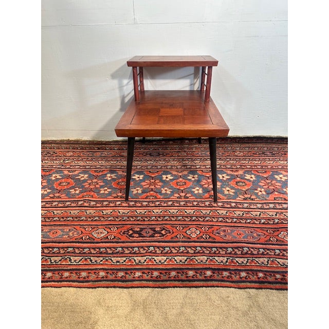 Add a touch of mid-century modern charm to your space with this elegant two-tier side table by Lane. Designed with clean...
