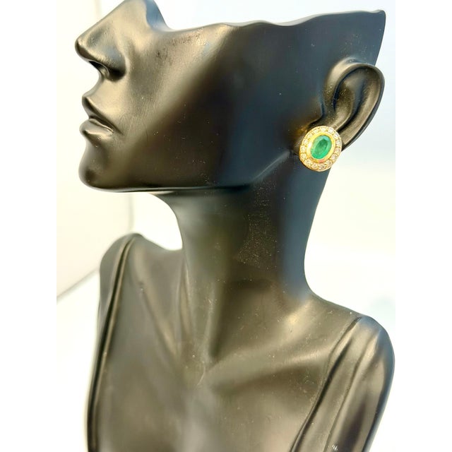These stunning post back earrings with Post back, a natural oval-shaped emerald weighing total approximately 4 carats,...