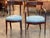 A set of seven klismos chairs showing the classic curved crest rail and gently splayed saber legs of the form. The...