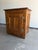 A beautifully crafted vintage Mission-style accent cabinet featuring solid oak construction, raised panel doors, and warm...