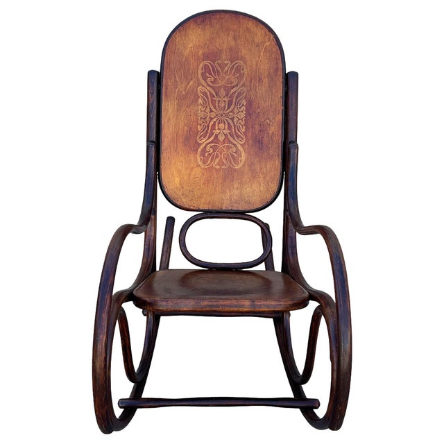 Turn of the century bent oak rocking chair w/ Art Nouveau pattern branded seat features an elegant, sculptural frame...