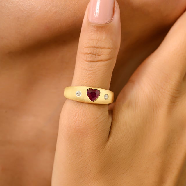 Luxury Heart Cut Ruby and Diamond Dome Band Ring in 18Kt Yellow Gold featuring 0.56 Ct heart-cut ruby at the center,...