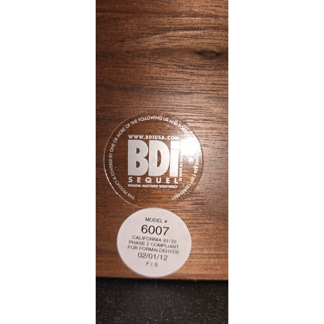 Modern BDI three-drawer file cabinet in a warm walnut finish with brushed aluminum pulls. This piece features clean...