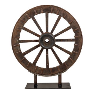 Antique Mounted Wood and Metal Wheel Welded to a Custom Metal Base For Sale