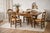 A beautiful antique French Provincial dining table featuring graceful Louis XV–style cabriole legs, a hand-carved...
