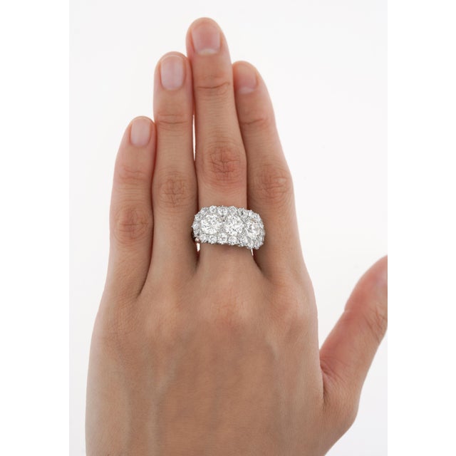 Vintage Art Deco three-stone natural diamond engagement ring. Set in platinum with a hand-carved filigree on the shank....