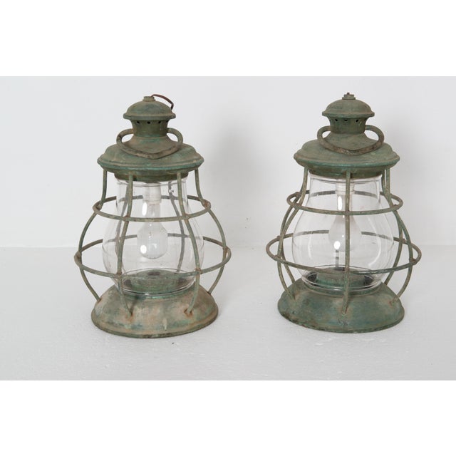 Pair of large vintage circular nautical copper lanterns with old bulbous circular glass. Large circular ring at the top of...